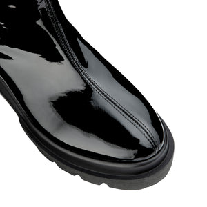 VALENTINO Boots in black patent leather with rubber sole and logo detail.